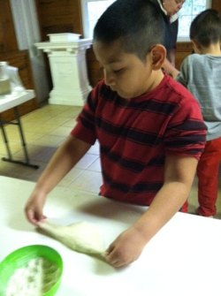 Nathen carefully prepares his dough for shaping.